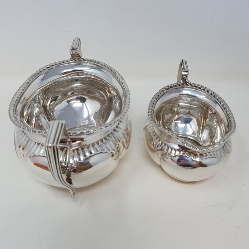 411 - An Edward VII silver oval sugar bowl, and a matching cream jug, Birmingham 1907, 10.6 ozt  Provenanc... 