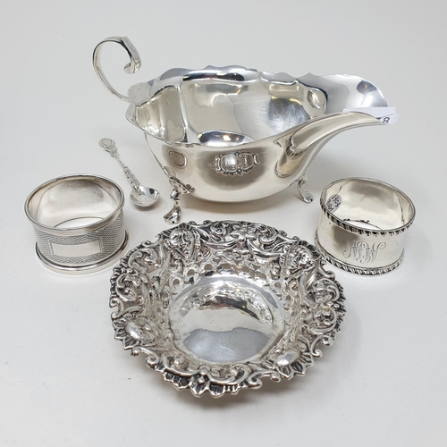 446 - A Victorian silver sifter spoon, London 1874, a pickle fork, a pierced heart shaped bowl, and a must... 