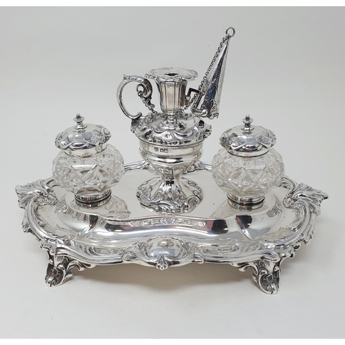 449 - An Edward VII silver desk stand, center bowl with a miniature chamber stick, flanked by cut glass in... 