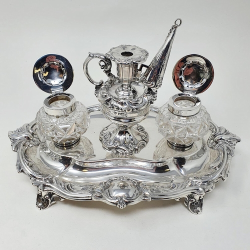 449 - An Edward VII silver desk stand, center bowl with a miniature chamber stick, flanked by cut glass in... 