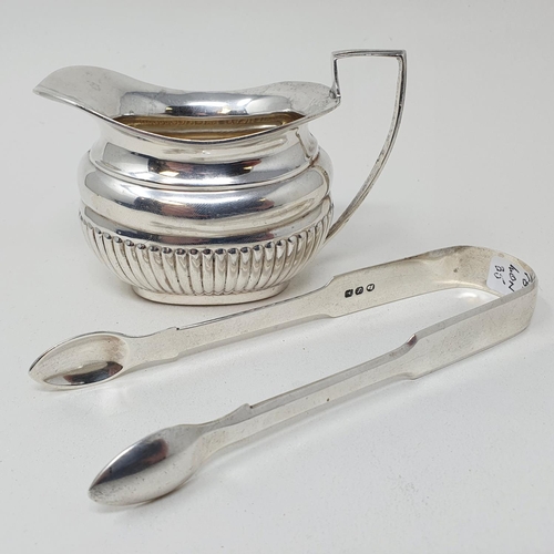 458 - A pair of George III silver sugar nips, London 1813, and an Edward VII cream jug, Chester 1934, 3.9 ... 