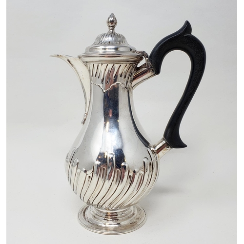 493 - A Victorian silver hot water jug, with an ebonised handle, base filled, London 1889 Provenance:  Fro... 