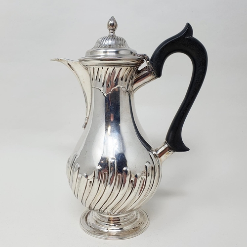 493 - A Victorian silver hot water jug, with an ebonised handle, base filled, London 1889 Provenance:  Fro... 