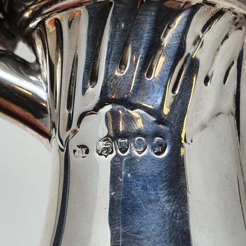 493 - A Victorian silver hot water jug, with an ebonised handle, base filled, London 1889 Provenance:  Fro... 