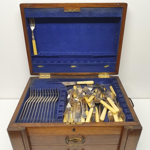 543 - A silver plated canteen of cutlery, in an oak case, with a hinged top above two drawers, note the iv... 