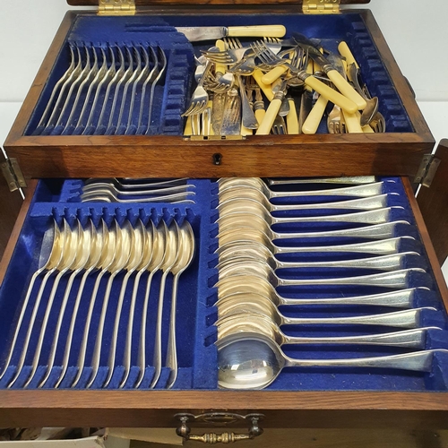 543 - A silver plated canteen of cutlery, in an oak case, with a hinged top above two drawers, note the iv... 