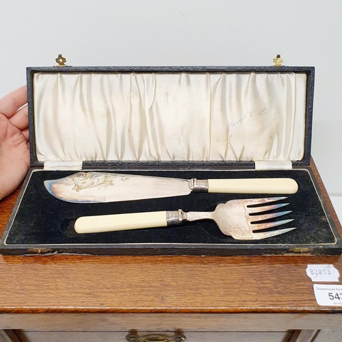 543 - A silver plated canteen of cutlery, in an oak case, with a hinged top above two drawers, note the iv... 