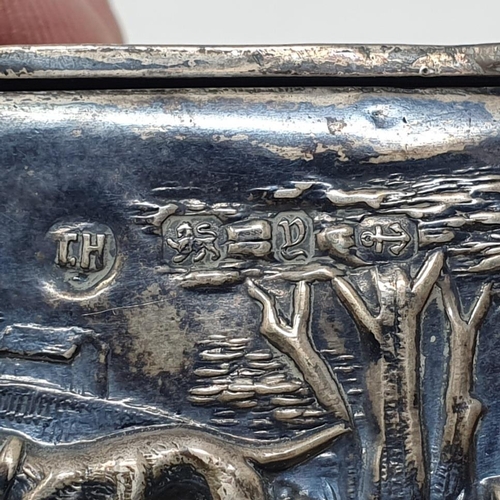 575 - A late Victorian rectangular silver box, the lid embossed figures, the sides boar hunting, and the u... 