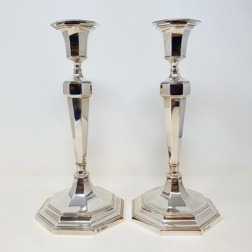 591 - A pair of silver octagonal table candlesticks, marks rubbed, probably Sheffield 1923, 26 cm high (2)