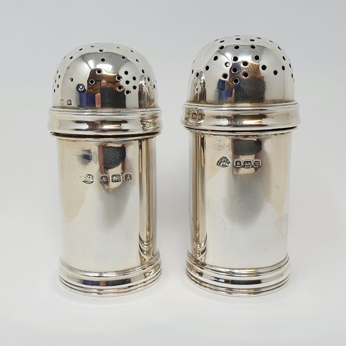 599 - A pair of silver pepperettes, Birmingham 1925/34, and two silver mustard pots, 8.3 ozt (4)