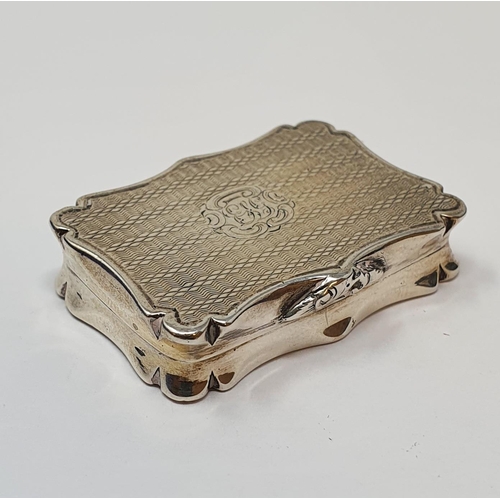 608 - An early Victorian silver vinaigrette, of shaped rectangular form, initialed and with engine turned ... 