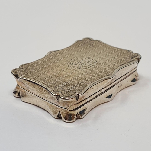 608 - An early Victorian silver vinaigrette, of shaped rectangular form, initialed and with engine turned ... 