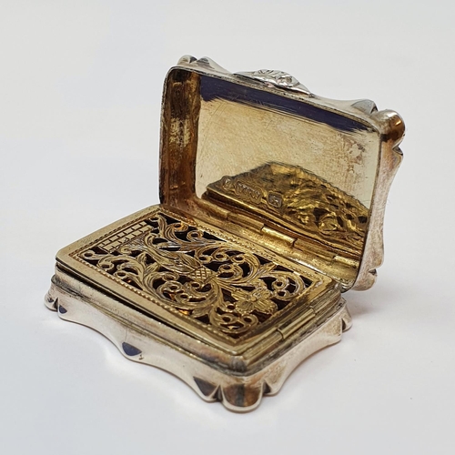 608 - An early Victorian silver vinaigrette, of shaped rectangular form, initialed and with engine turned ... 