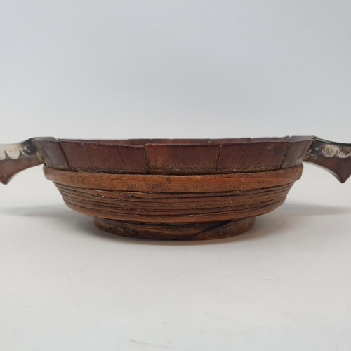 617 - An early 19th century Scottish treen quaich, with white metal mounts, 22 cm wide