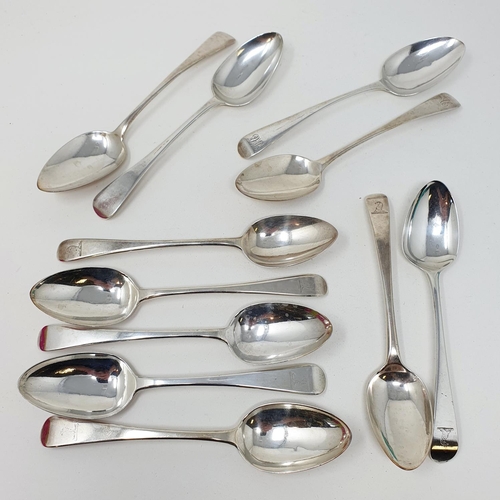 624 - A matched set of eleven silver Old English pattern dessertspoons, crested or initialed, various date... 