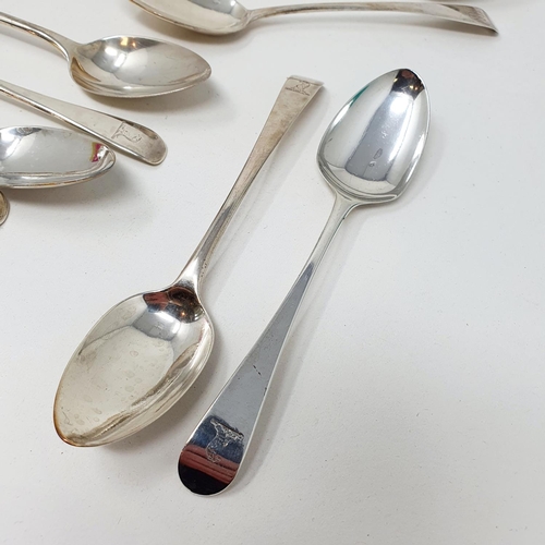 624 - A matched set of eleven silver Old English pattern dessertspoons, crested or initialed, various date... 