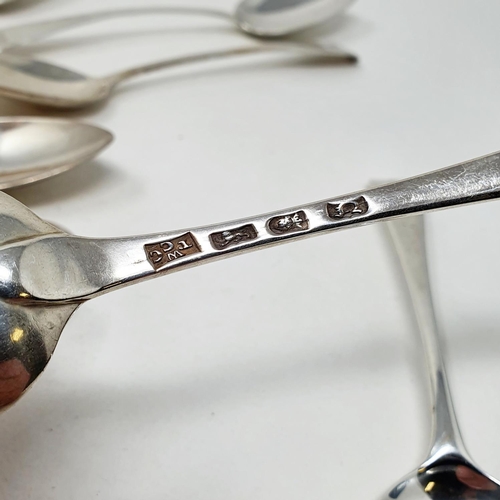 624 - A matched set of eleven silver Old English pattern dessertspoons, crested or initialed, various date... 