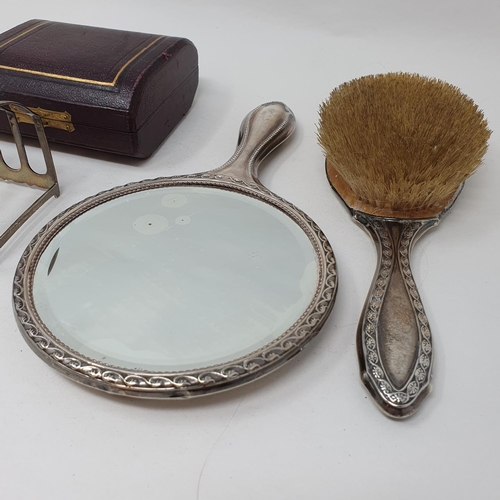 627 - A silver toast rack, set of aesthetic style napkin rings, a silver backed mirror and brush, various ... 