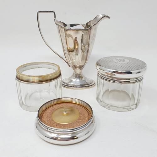 690 - A George III style cream jug, Birmingham 1906, 2.9 ozt, and two glass and silver mounted jars (3)