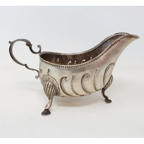 573 - An 18th century style silver sauce boat, with embossed decoration, London 1899, 7.4 ozt