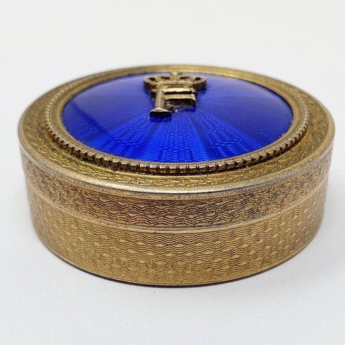 707 - A Continental silver gilt and blue enamel pill box, stamped A H. NAGUIB BUY, 4.5 cm diameter