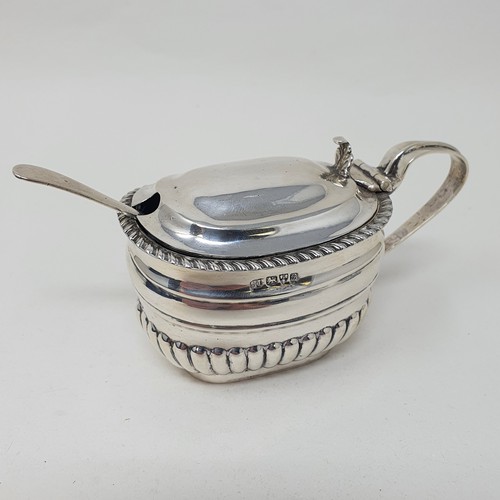 440 - An Edward VII silver mustard pot and spoon, Chester 1902, with a blue glass liner  Provenance: From ... 