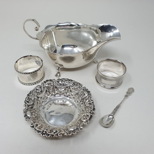 518 - A George V silver sauce boat, Sheffield 1935,  two napkin rings, a pin tray, and mustard spoon, 5.2 ... 