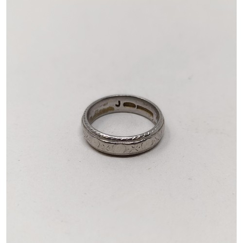 813 - A platinum wedding band,  7.3 g