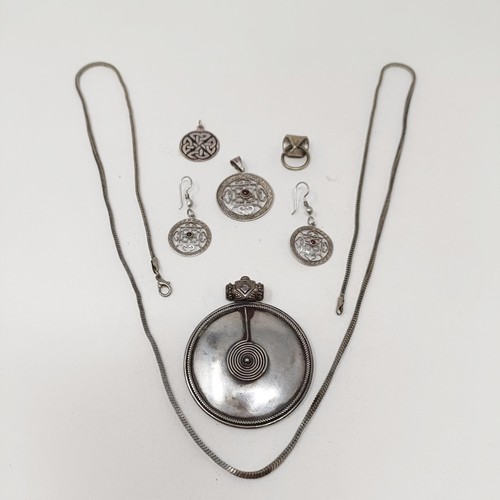 998A - A Tibetan pendant, and matching earrings, a silver pendant, and assorted jewellery