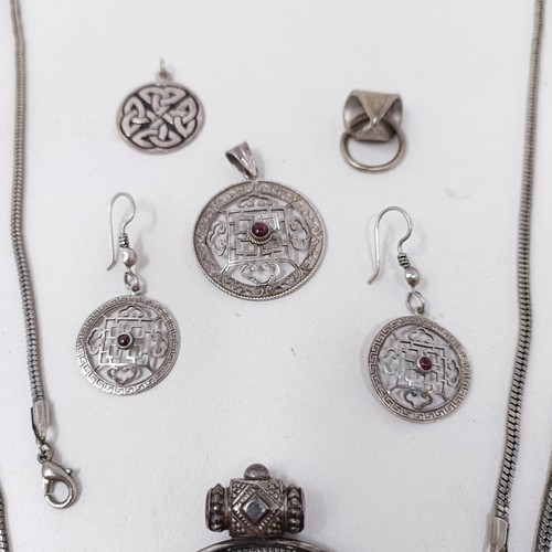 998A - A Tibetan pendant, and matching earrings, a silver pendant, and assorted jewellery