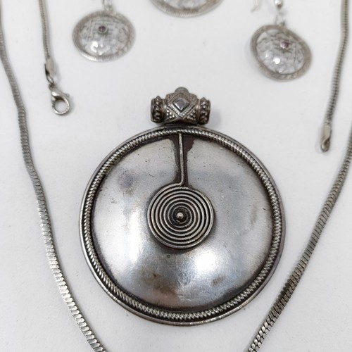 998A - A Tibetan pendant, and matching earrings, a silver pendant, and assorted jewellery