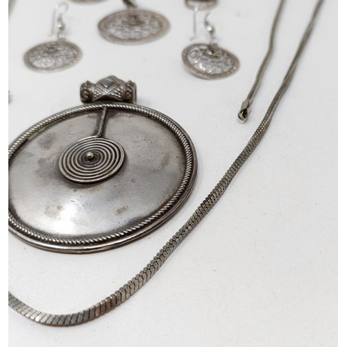 998A - A Tibetan pendant, and matching earrings, a silver pendant, and assorted jewellery