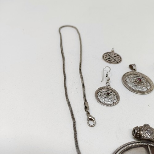 998A - A Tibetan pendant, and matching earrings, a silver pendant, and assorted jewellery