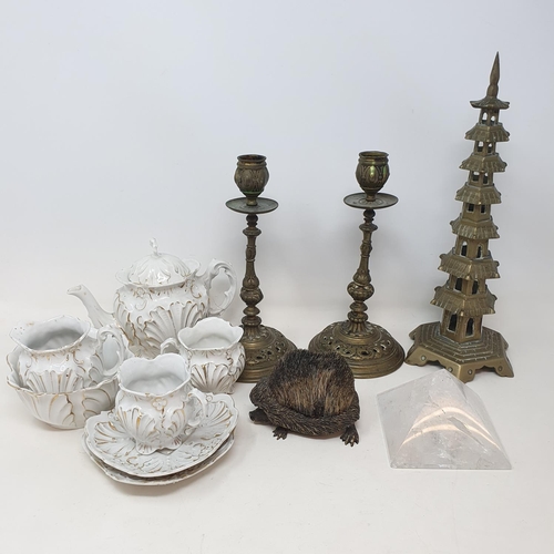 1002 - A pair of brass candlesticks, 21 cm high, a pen wipe in the form of a hedgehog, a bachelor's tea set... 