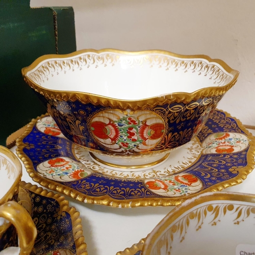 1006 - An early 19th century part tea service, having a blue border with roundels, decorated flowers highli... 