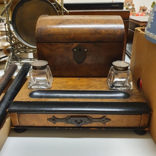 1039 - An early 20th century walnut desk stand, with glass inkwells with silver mounts, 30 cm wide, a domed... 