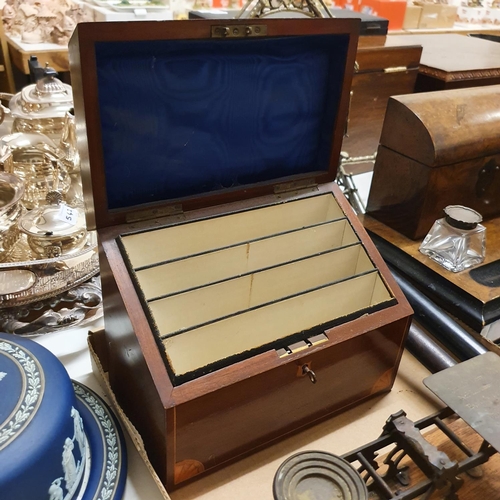 1039 - An early 20th century walnut desk stand, with glass inkwells with silver mounts, 30 cm wide, a domed... 