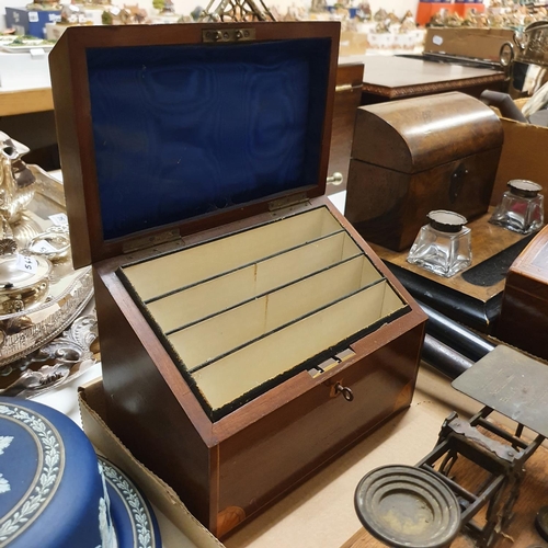 1039 - An early 20th century walnut desk stand, with glass inkwells with silver mounts, 30 cm wide, a domed... 