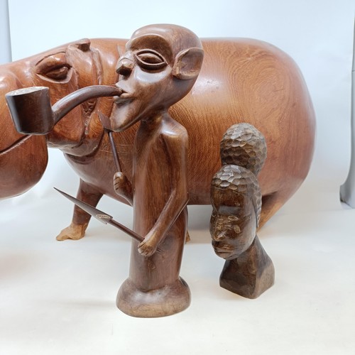 1098 - A large African carving of a hippo, 85 cm wide, and two other carvings (3)