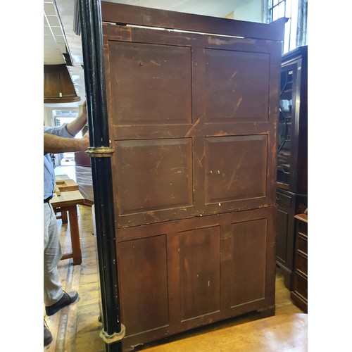 1229 - A 19th century mahogany linen press, the top having two doors, to reveal slides, on a base with two ... 