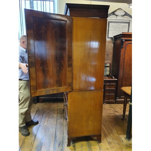 1229 - A 19th century mahogany linen press, the top having two doors, to reveal slides, on a base with two ... 