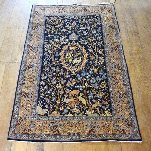 1212 - A Persian blue ground silk rug, the centre decorated birds, animals and flowers, 165 x 110 cm