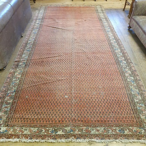 1213 - A Persian red ground carpet, 428 x 186 cm