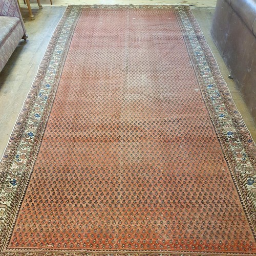 1213 - A Persian red ground carpet, 428 x 186 cm