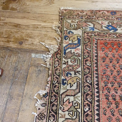 1213 - A Persian red ground carpet, 428 x 186 cm