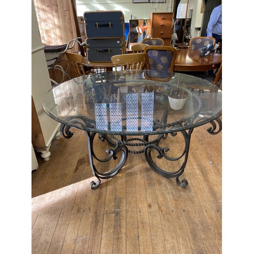 1273 - An unusual wrought iron dining table, with a glass top, 154 cm diameter