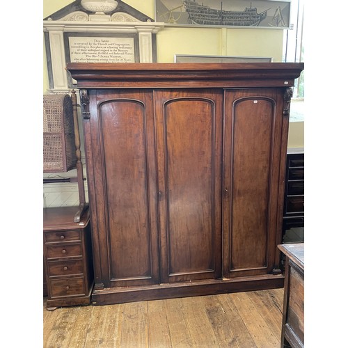 1256 - A 19th century mahogany triple wardrobe, 192 cm wide