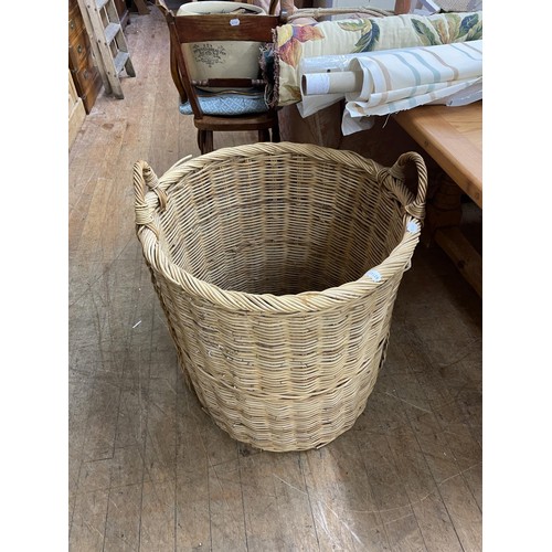 1283 - A wicker dog bed, four rolls of material, and a wicker log basket (6)