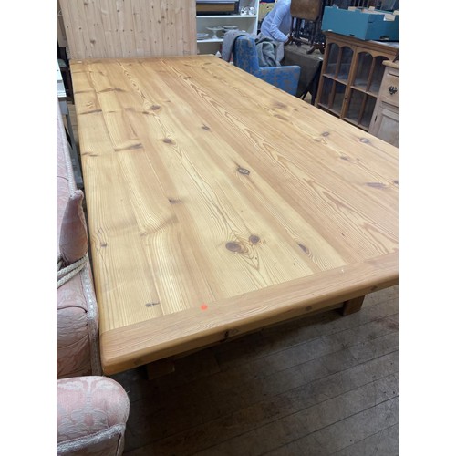 1282 - A large pine kitchen table, on turned legs, the top 272 x 120 cm