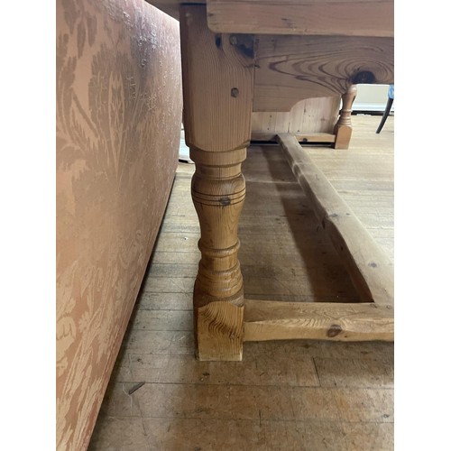 1282 - A large pine kitchen table, on turned legs, the top 272 x 120 cm